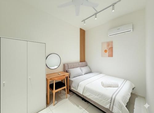 a bedroom with a bed and a table with a mirror at Majestic Residence KLCC By AFA in Kuala Lumpur