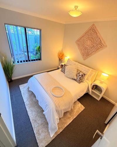 a bedroom with a bed and a large window at Glamorous Getaway in Mandurah