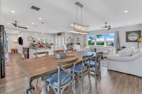 a kitchen and living room with a table and chairs at Inviting Lakeview Home l Pool l Close to Beaches in Marco Island