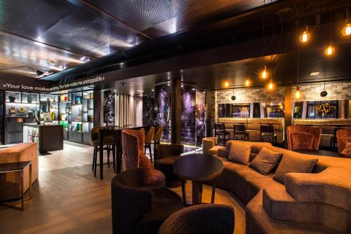 a bar with couches and tables in a room at Pestana CR7 Lisboa in Lisbon