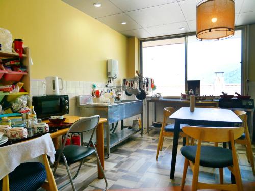 a kitchen with a table and chairs and a counter at SDGs BASE AQUA PLUS in Hakusan