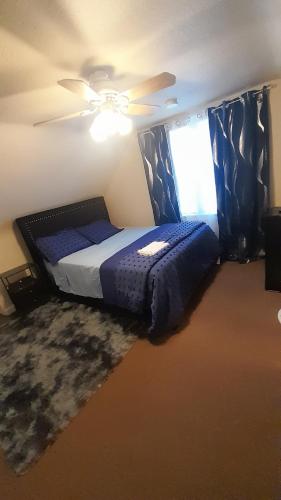 a bedroom with a bed and a ceiling fan at GA home in Milwaukee