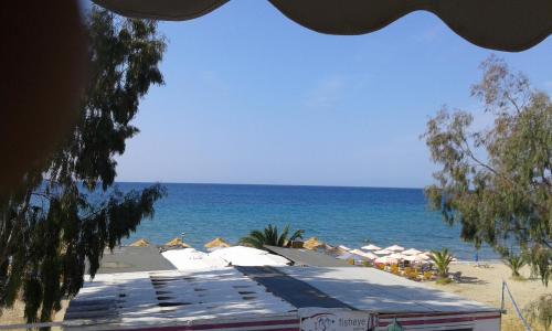 a view of a beach with umbrellas and the ocean at Seaside Studios in Paralia Dionysiou