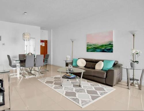 a living room with a couch and a table at Oceanfront Penthouse with Intercoastal Views in Hollywood Beach