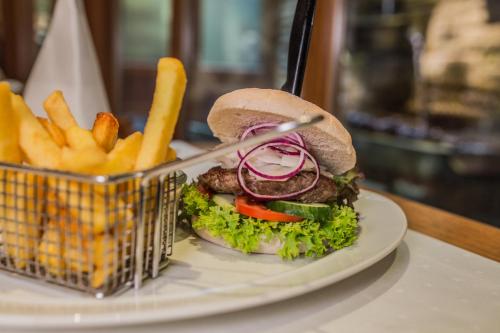 a sandwich and french fries on a plate at Central-Hotel Kaiserhof in Hannover