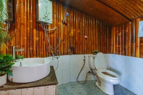 a bathroom with a tub and a toilet and a sink at ดานบนดินCamping in Ban Thung Phan Ha
