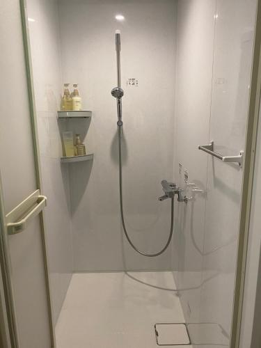 a bathroom with a shower with a glass door at fujisakaya藤坂屋 in Tamba-sasayama