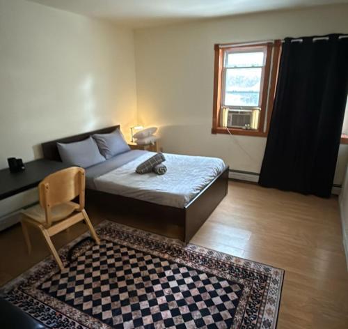 a bedroom with a bed and a checkered rug at Sunny Apt by the park Mins away from midtown New York in Jersey City