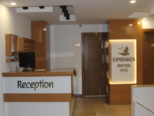 a reception desk with a sign for a hotel at Esperanza Hotel in Antalya
