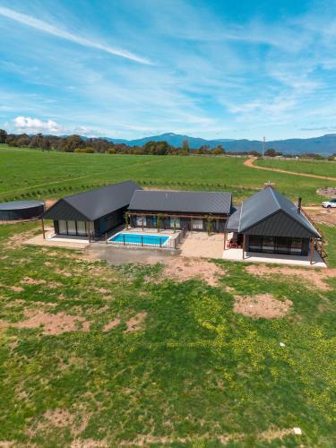an aerial view of a house in a field at Half Mile High - Merrijig - Sleeps 10 in Barwite
