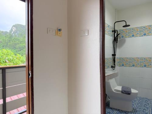 a bathroom with a toilet and a window at Chongkhao Resort- Phi Phi Island in Phi Phi Don