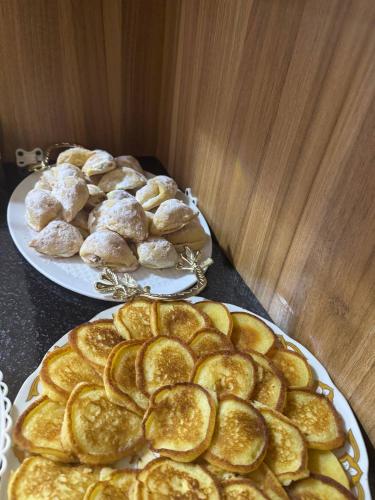 two plates of breads and rolls on a table at Asia Central Boutique in old city in Bukhara