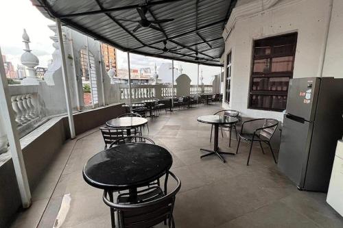 a row of tables and chairs on a balcony at Hotel AL Amin in Kuala Lumpur
