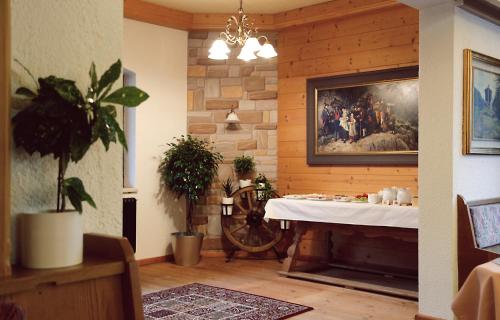 a living room with a table and a fireplace at Hotel & Suites Glück Auf in Mayrhofen