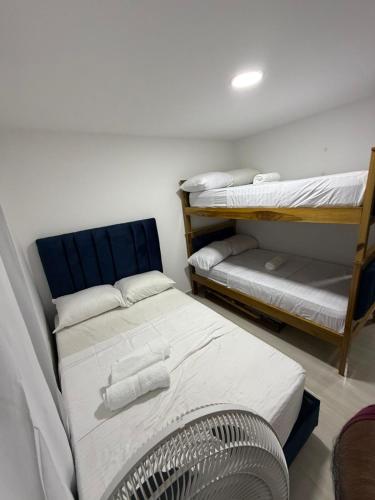 a room with two bunk beds and a fan at apartamento M&C in San Gil