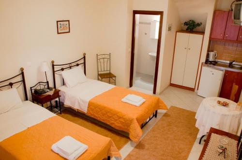 a hotel room with two beds and a bathroom at Nefeli in Levidhion