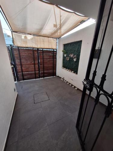 an empty room with a door and a fence at Casa Ana Victoria in Morelia