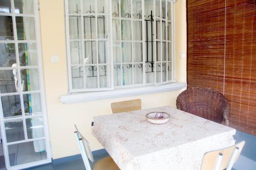 a table and chairs in a room with a window at Welcome Holidays in Grand Baie