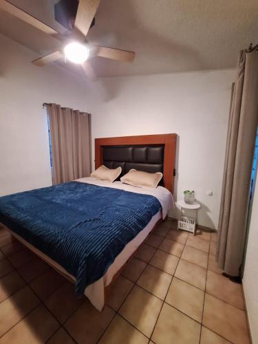 a bedroom with a bed and a ceiling fan at Casa Ana Victoria in Morelia