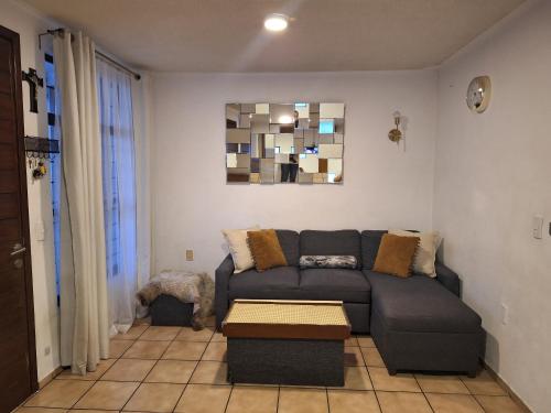 a living room with a couch and a table at Casa Ana Victoria in Morelia
