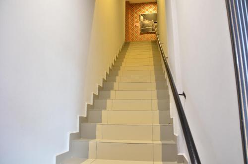 a stairway in a building with white stairs at D'Metro Hotel in Shah Alam