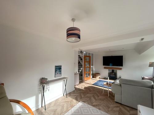 a living room with a couch and a tv at Hamble Haven in Lower Swanwick