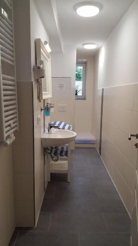 a bathroom with a sink and a toilet in it at Pension Fischerjung in Rostock