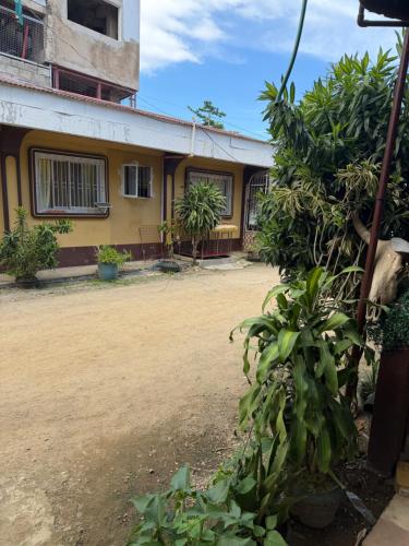a building with a lot of plants in front of it at Maria kulafu studio 2 in Masbate