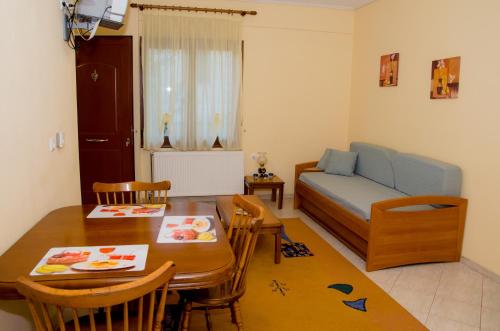 a living room with a table and a dining room at Nefeli in Levidhion