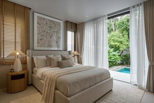Ένα ή περισσότερα κρεβάτια σε δωμάτιο στο Premium Villa Botanica 3-BR with Pool and Garden
