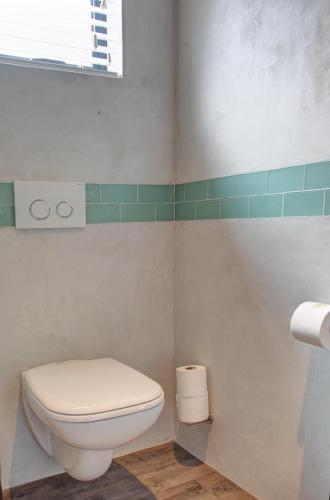 a bathroom with a toilet and a window at Knysna Hollow Country Estate in Knysna