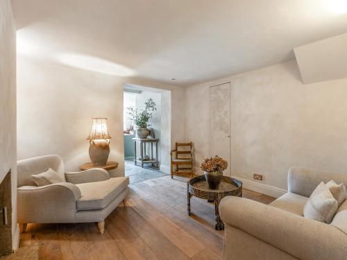 a living room with two couches and a table at Chantry House in Shoreham-by-Sea