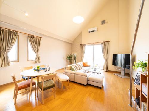 a living room with a couch and a table at The Global Tower in Niihama
