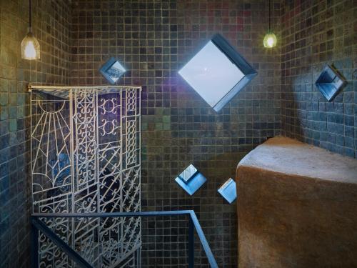 een badkamer met een raam en een bakstenen muur bij Community Lodge Nepal - Chhimeki Lodge in Nagarkot