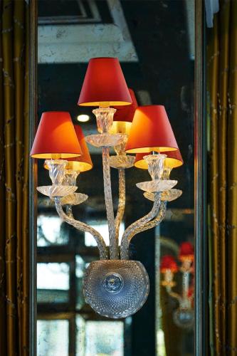 a chandelier with two lamps in front of a mirror at Bromley Court Hotel London in Bromley