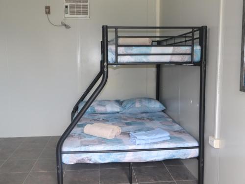 two bunk beds in a room with towels on them at Tez's Backpacking Lodge in Maria