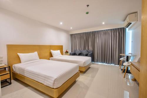 Voodi või voodid majutusasutuse Fourium Pattaya Hotel and Serviced Residence toas