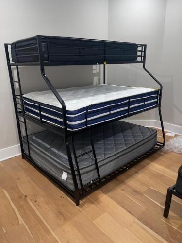 a black bunk bed frame with two bottom bunk beds at Downtown Baton Rouge 7BR Haven in Baton Rouge