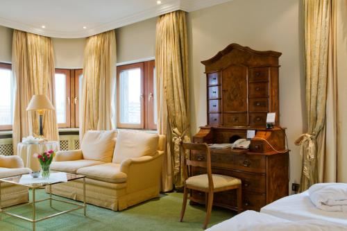a hotel room with a bed and a desk and a chair at Central-Hotel Kaiserhof in Hannover