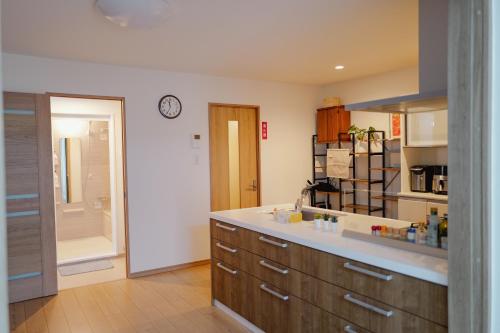 a kitchen with a sink and a counter top at The Prime Minato 2-Bedroom Suite Near Tokyo Tower, 2 Mins Walk to Asakusa Line, Direct Access From HND, NRT Airport in Tokyo