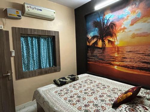 a bedroom with a bed and a picture of a beach at Mato Shree Aashray Homestay in Gaya