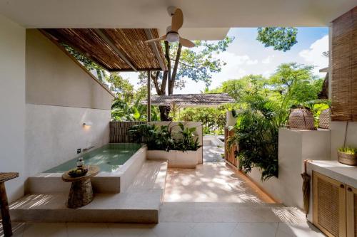 a bathroom with a hot tub in a house at Wanan Tinglan Wild Luxury Resort Designer Hotel in Jinghong