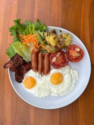 De Hom Hotel Mae Hong Son في ماي هونغ سون: طبق من طعام الإفطار مع البيض والخضروات