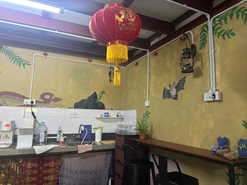 an office with a desk with a red lamp at The Cave - Adults Only in Tanah Rata