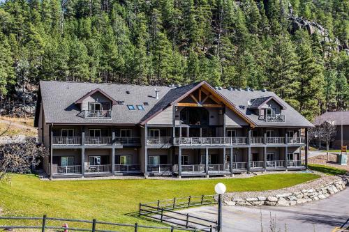 a large resort building with a large yard and trees at K Bar S Lodge, an Ascend Collection Hotel in Keystone