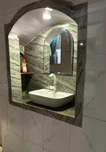 a sink in a bathroom with a mirror at Mato Shree Aashray Homestay in Gaya