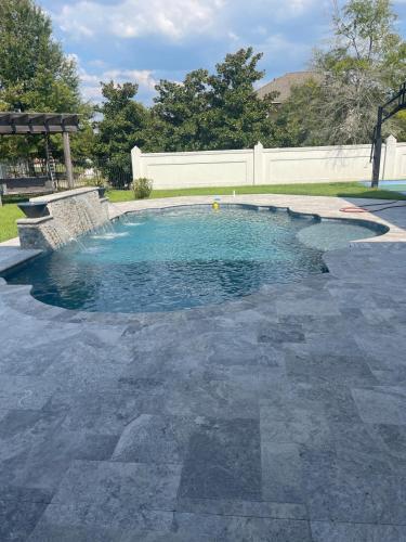 a swimming pool with blue water in a yard at Cute Home with some Razzle Dazzle in Baton Rouge