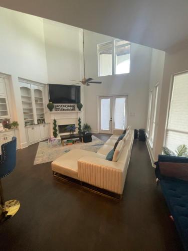 a large living room with a couch and a tv at Cute Home with some Razzle Dazzle in Baton Rouge