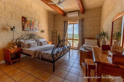 Ένα ή περισσότερα κρεβάτια σε δωμάτιο στο Orchidea Xaghra