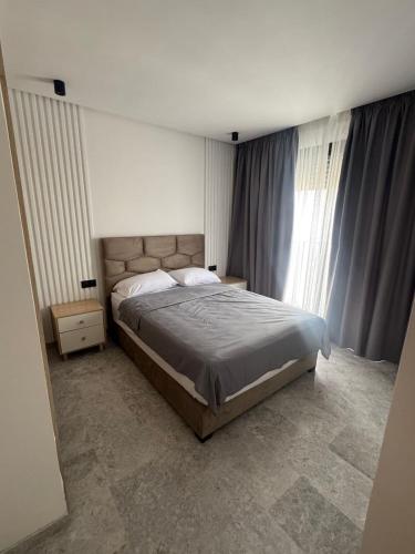 a bedroom with a bed and a large window at Luxury city center tram abdelmoumen in Casablanca